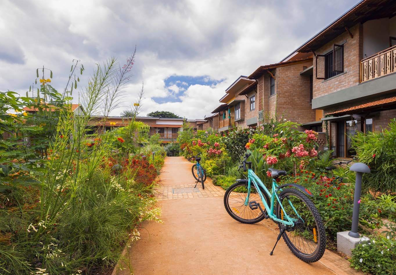 Saarang West car-free street with townhouses, lush gardens, and bicycles